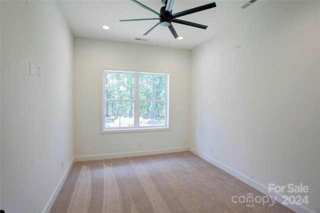 carpeted empty room featuring ceiling fan