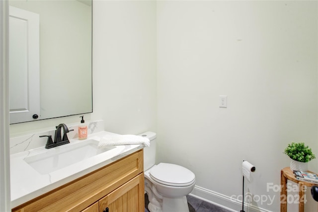 bathroom featuring toilet, vanity, and tile patterned floors