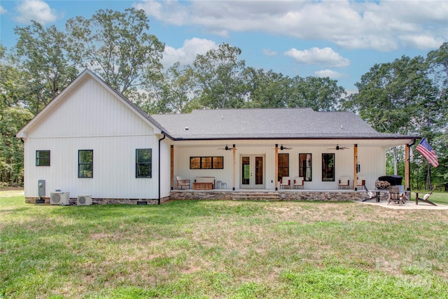 back of property with ceiling fan, a patio area, a yard, central air condition unit, and french doors