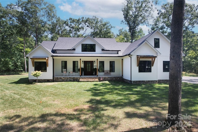 modern farmhouse style home with a front yard and a porch