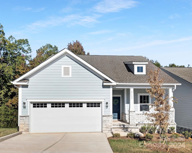 view of front facade with covered porch and a garage