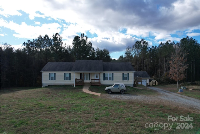 view of front of home featuring an outbuilding and a front lawn