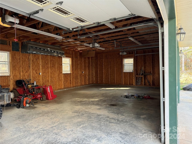 garage featuring wood walls and a garage door opener