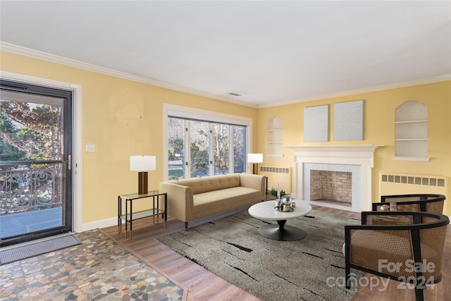 living room with wood-type flooring, built in features, radiator, and ornamental molding