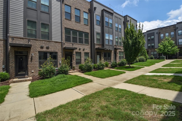 view of property's community with a lawn