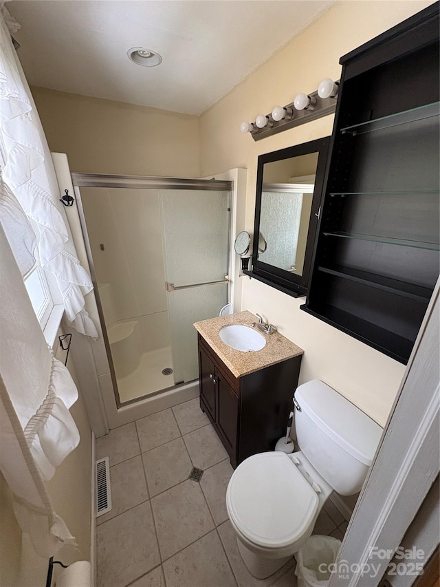 bathroom featuring visible vents, toilet, tile patterned flooring, vanity, and a shower stall