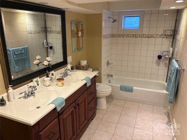 bathroom featuring washtub / shower combination, a sink, toilet, and tile patterned floors