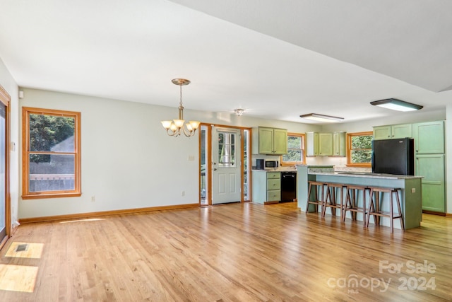 unfurnished living room with light hardwood / wood-style flooring and a chandelier