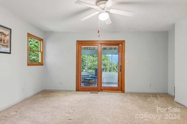 carpeted empty room with ceiling fan