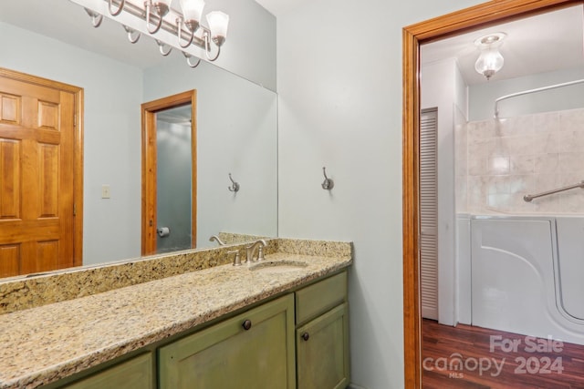 bathroom featuring a shower, vanity, and wood-type flooring