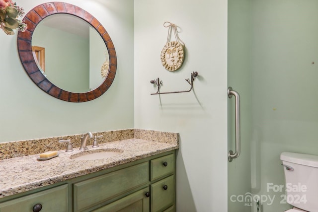 bathroom featuring toilet and vanity