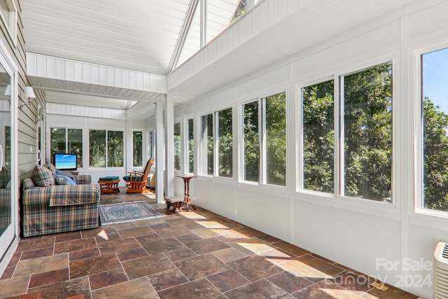 unfurnished sunroom with a wealth of natural light and lofted ceiling