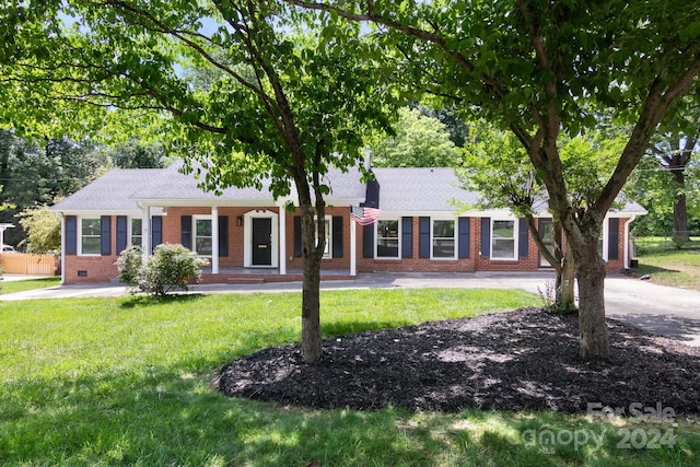 ranch-style house with a front lawn