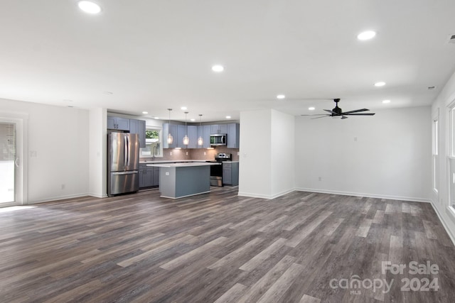 unfurnished living room with ceiling fan and hardwood / wood-style flooring