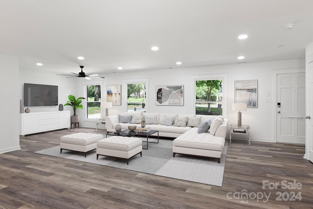 living room with ceiling fan and dark wood-type flooring