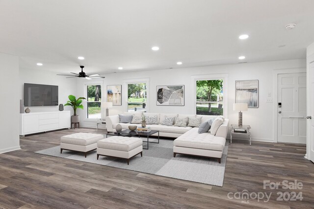 living area featuring recessed lighting, dark wood finished floors, baseboards, and ceiling fan