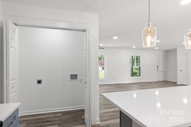 interior space featuring decorative light fixtures, baseboards, dark wood-type flooring, and recessed lighting
