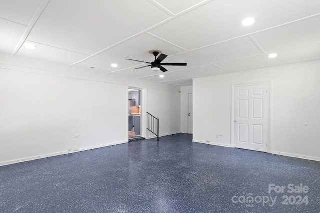 unfurnished living room with baseboards, a ceiling fan, dark speckled floor, and recessed lighting
