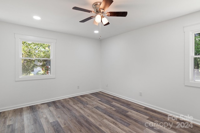 empty room featuring plenty of natural light, ceiling fan, and hardwood / wood-style flooring