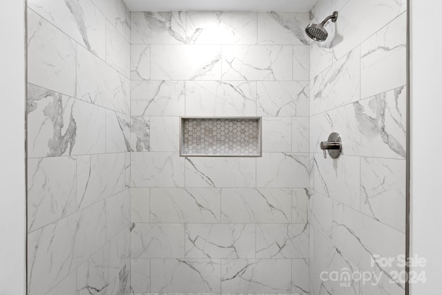 full bath with a tile shower