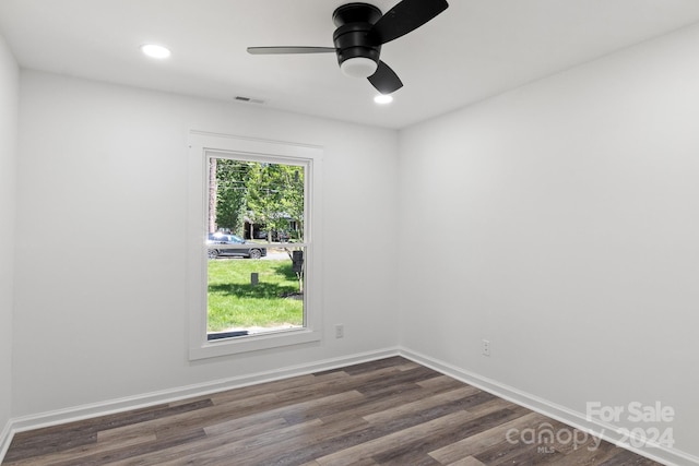 empty room with dark wood finished floors, visible vents, baseboards, recessed lighting, and ceiling fan