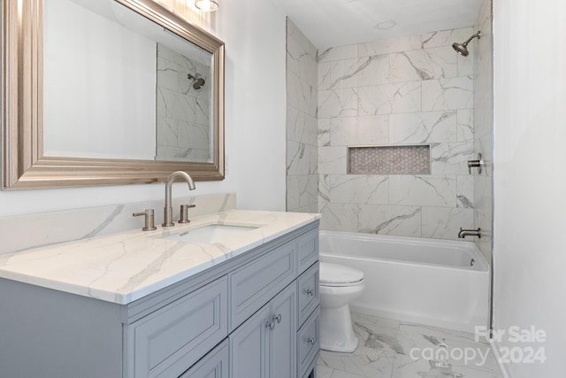 full bathroom featuring tile patterned floors, vanity, tiled shower / bath combo, and toilet