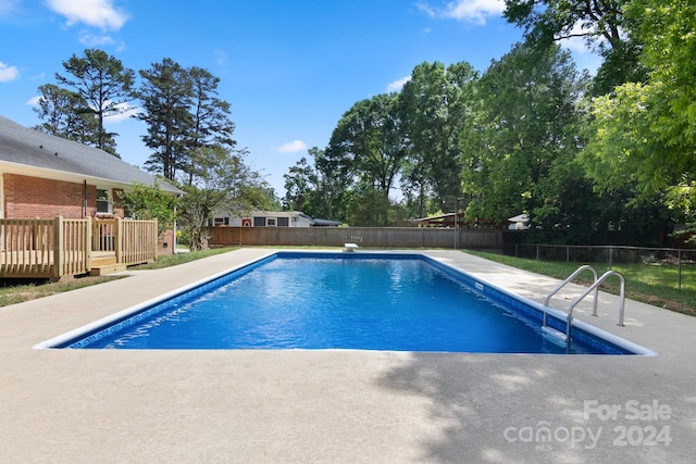 view of swimming pool with a deck