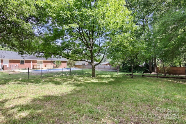 view of yard with a fenced in pool