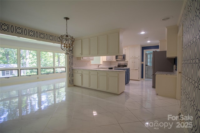 kitchen with hanging light fixtures, stainless steel appliances, tasteful backsplash, a chandelier, and light tile patterned floors