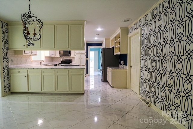 kitchen featuring decorative backsplash, appliances with stainless steel finishes, green cabinets, and sink