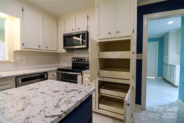 kitchen with white cabinets, decorative backsplash, light stone countertops, light tile patterned flooring, and stainless steel appliances