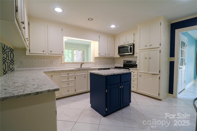 kitchen featuring electric range, a kitchen island, light stone counters, and sink