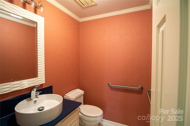 bathroom with vanity, toilet, and ornamental molding