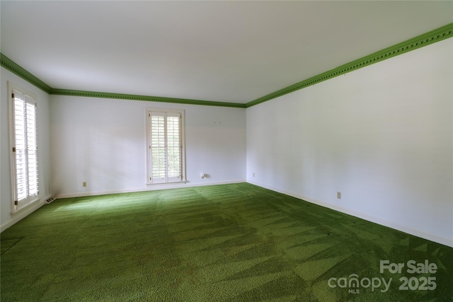 carpeted empty room featuring plenty of natural light and ornamental molding