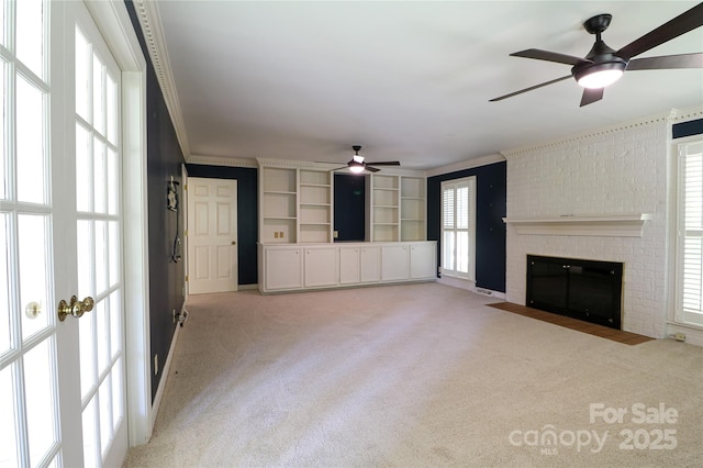 unfurnished living room featuring a fireplace, plenty of natural light, and ornamental molding