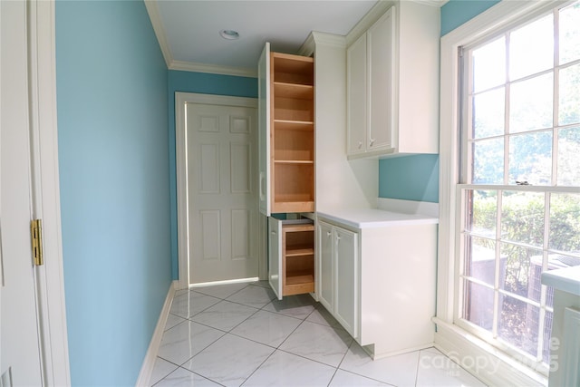 interior space featuring light tile patterned floors and ornamental molding