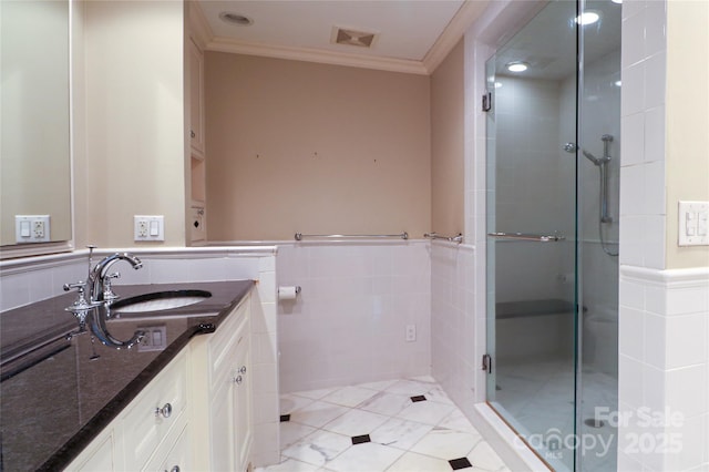 bathroom with vanity, tile patterned floors, a shower with door, and crown molding