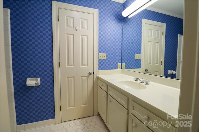 bathroom with tile patterned flooring, vanity, and ornamental molding