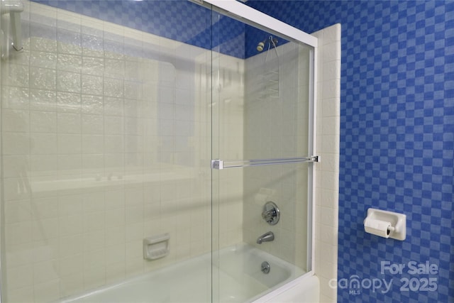 bathroom with shower / bath combination with glass door