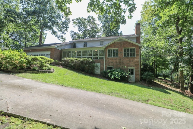 view of front of home featuring a garage and a front lawn