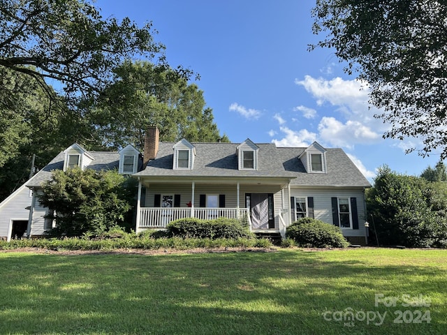 cape cod home with a front lawn and a porch