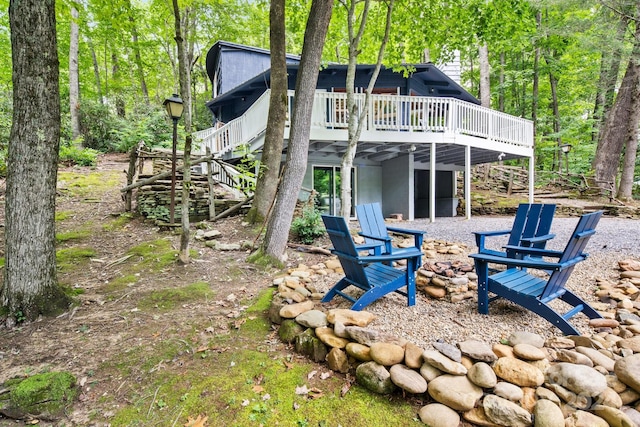 rear view of house featuring a wooden deck