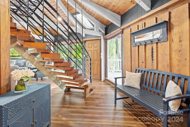 interior space featuring vaulted ceiling with beams, wood walls, wood ceiling, and wood finished floors