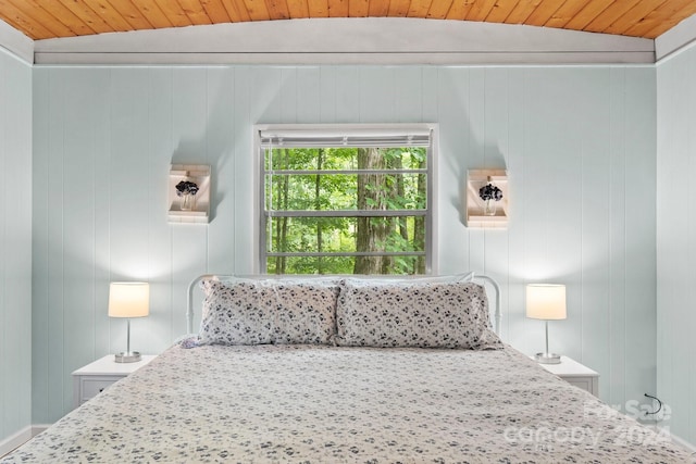 bedroom featuring vaulted ceiling and wood ceiling