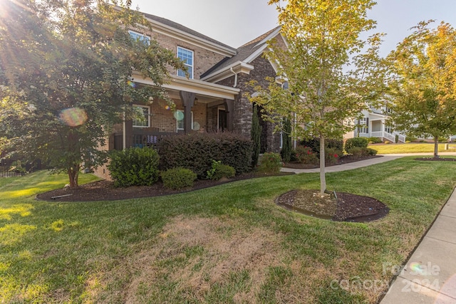 craftsman inspired home featuring a porch and a front yard