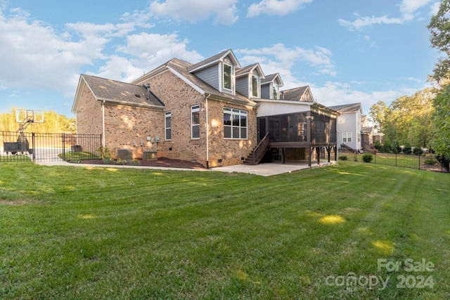 rear view of property with a patio area, a lawn, cooling unit, and a sunroom