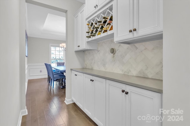 interior space with white cabinets, dark hardwood / wood-style floors, and backsplash