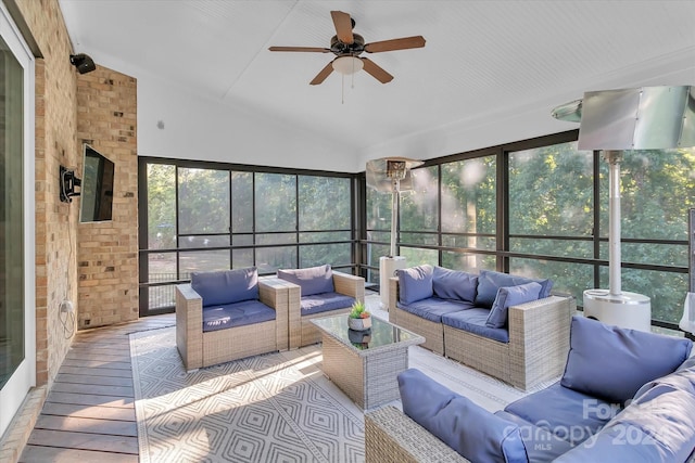 sunroom featuring vaulted ceiling and ceiling fan