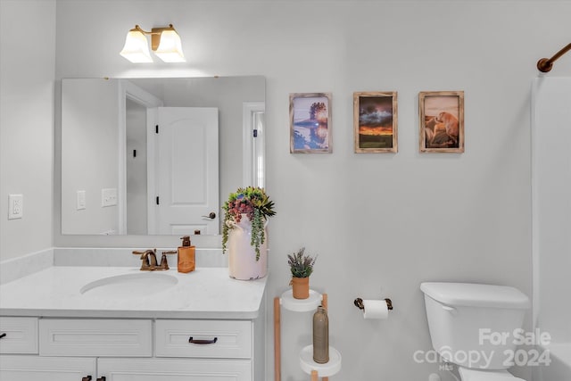 bathroom featuring vanity and toilet