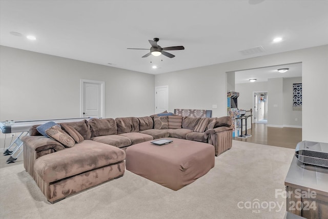 carpeted living room featuring ceiling fan